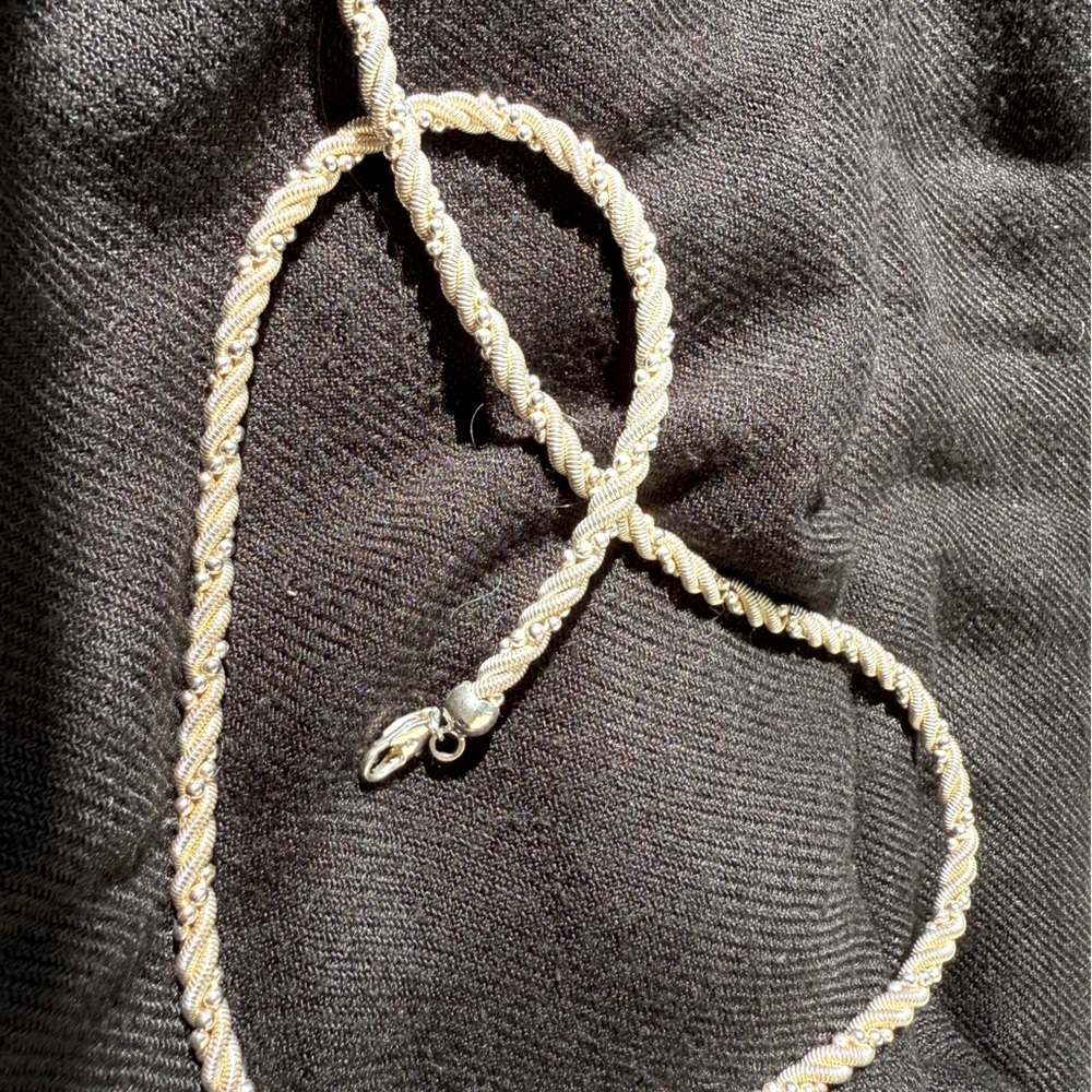 Sterling silver rope necklace with added silver beads.